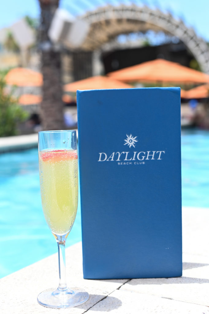 Daylight Beach cocktail next to menu poolside