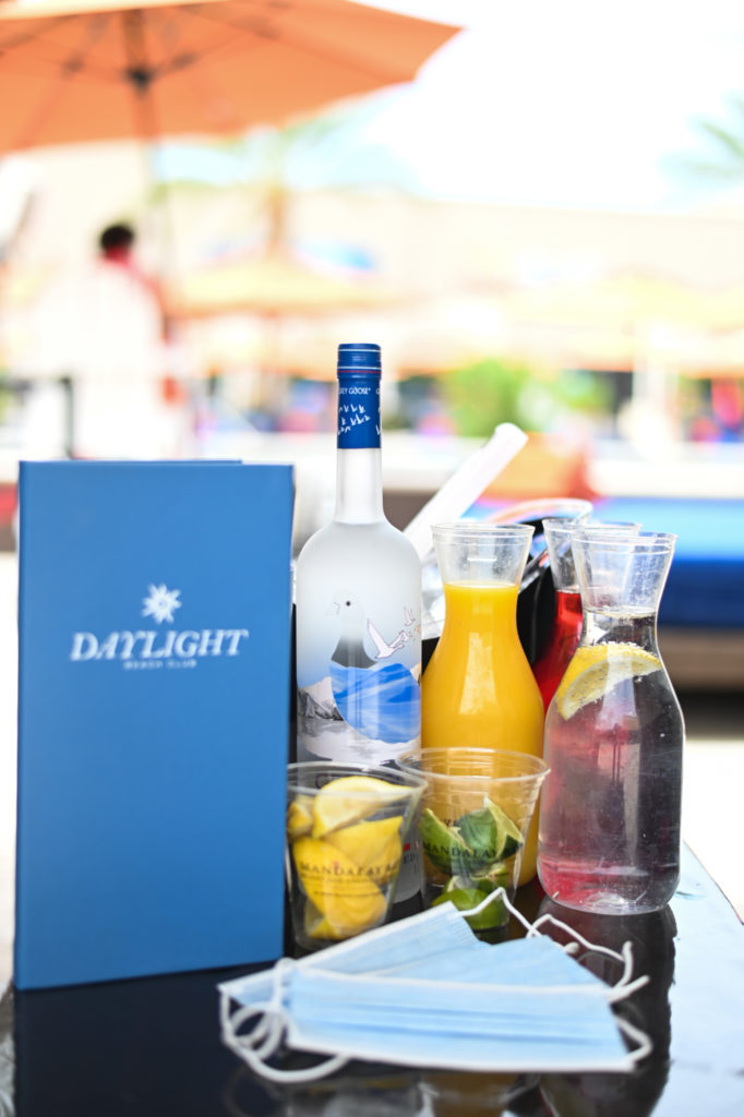 Daylight Beach drink menu, drinks, and masks on table
