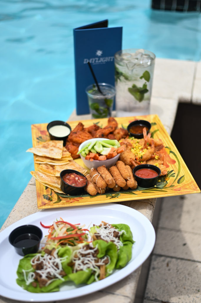 Poolside dining at Daytime Beach with food and drinks