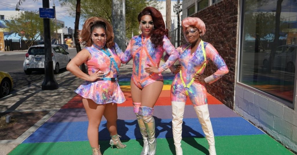 Three people posing at the Bottomless Drag Brunch at the Garden Las Vegas