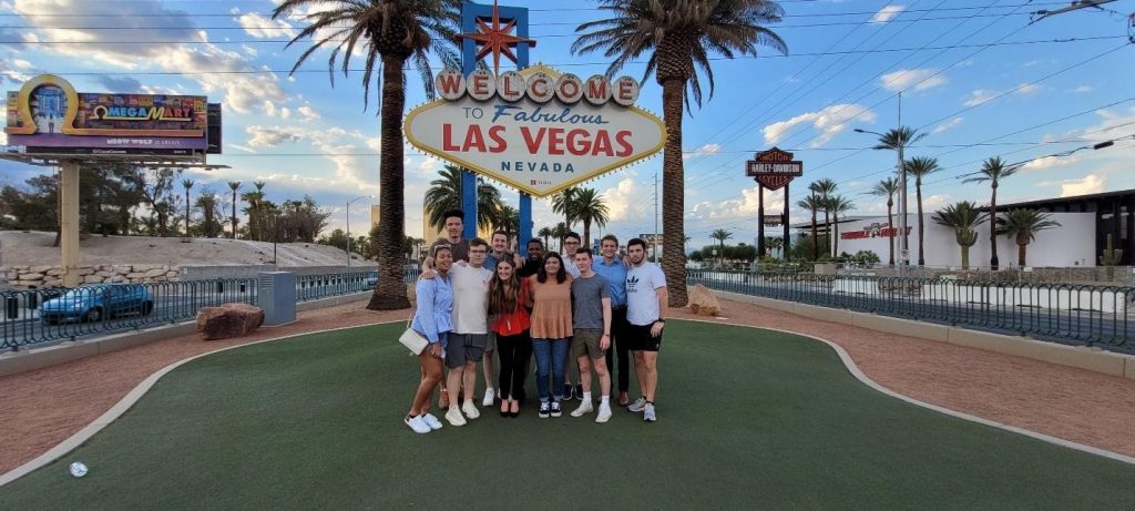 Station Casinos former interns standing at Las Vegas sign