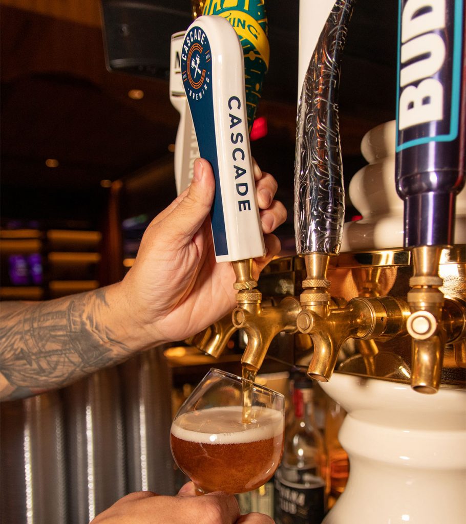 Bartender pouring a cascade sour at Casbar Lounge
