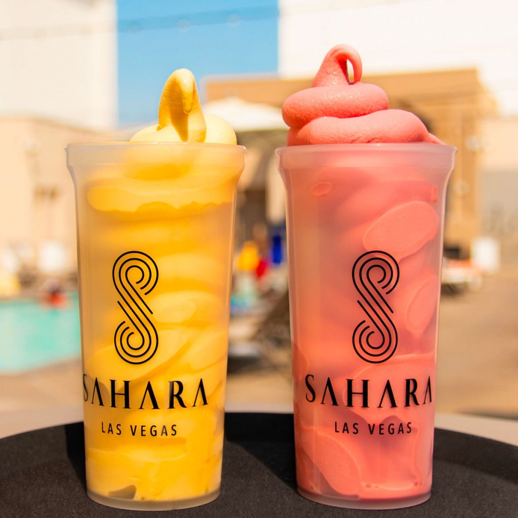 Yellow and Pink Dole Whip Margarita's with Sahara Las Vegas branding on the cup