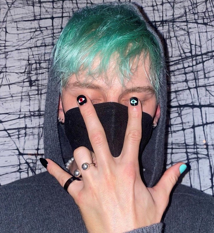 MGK with green hair and painted nails