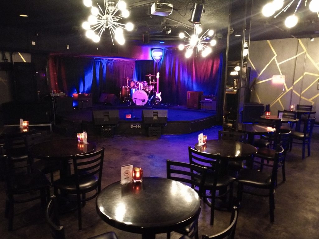 Sand Dollar Lounge stage and tables