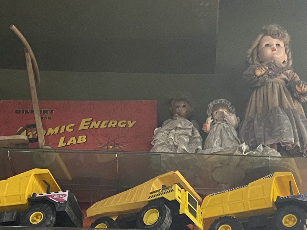 Atomic Energy Lab box next to spooky German vintage dolls