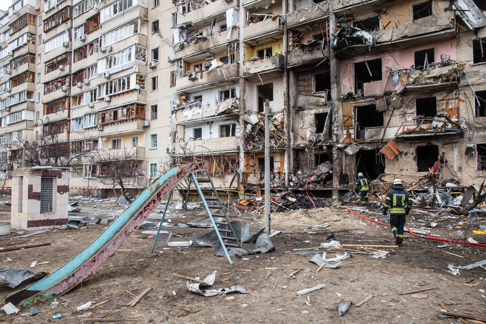 KYIV, UKRAINE - Feb. 25, 2022: War of Russia against Ukraine. A residential building damaged by an enemy aircraft in the Ukrainian capital Kyiv / Shutterstock