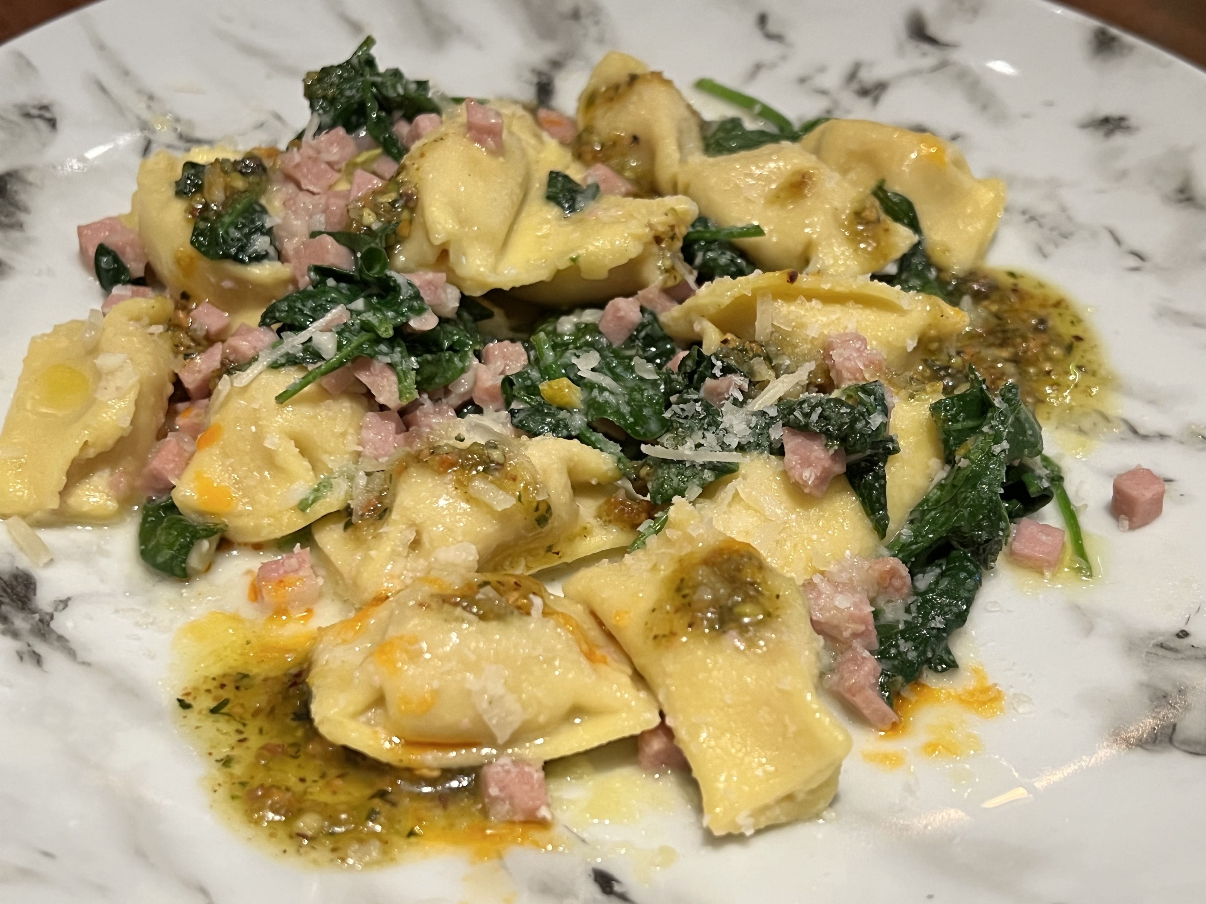 Mortadella Agnolotti with spinach, pistachio pesto, and parmesan lunch portion