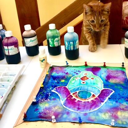 Amelia's vibrant artwork and cat 