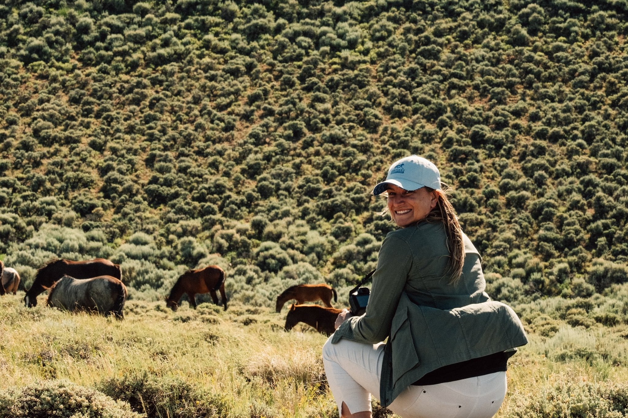 Behind the scenes of Wild Beauty photo of Director Ashley Avis with wild horses