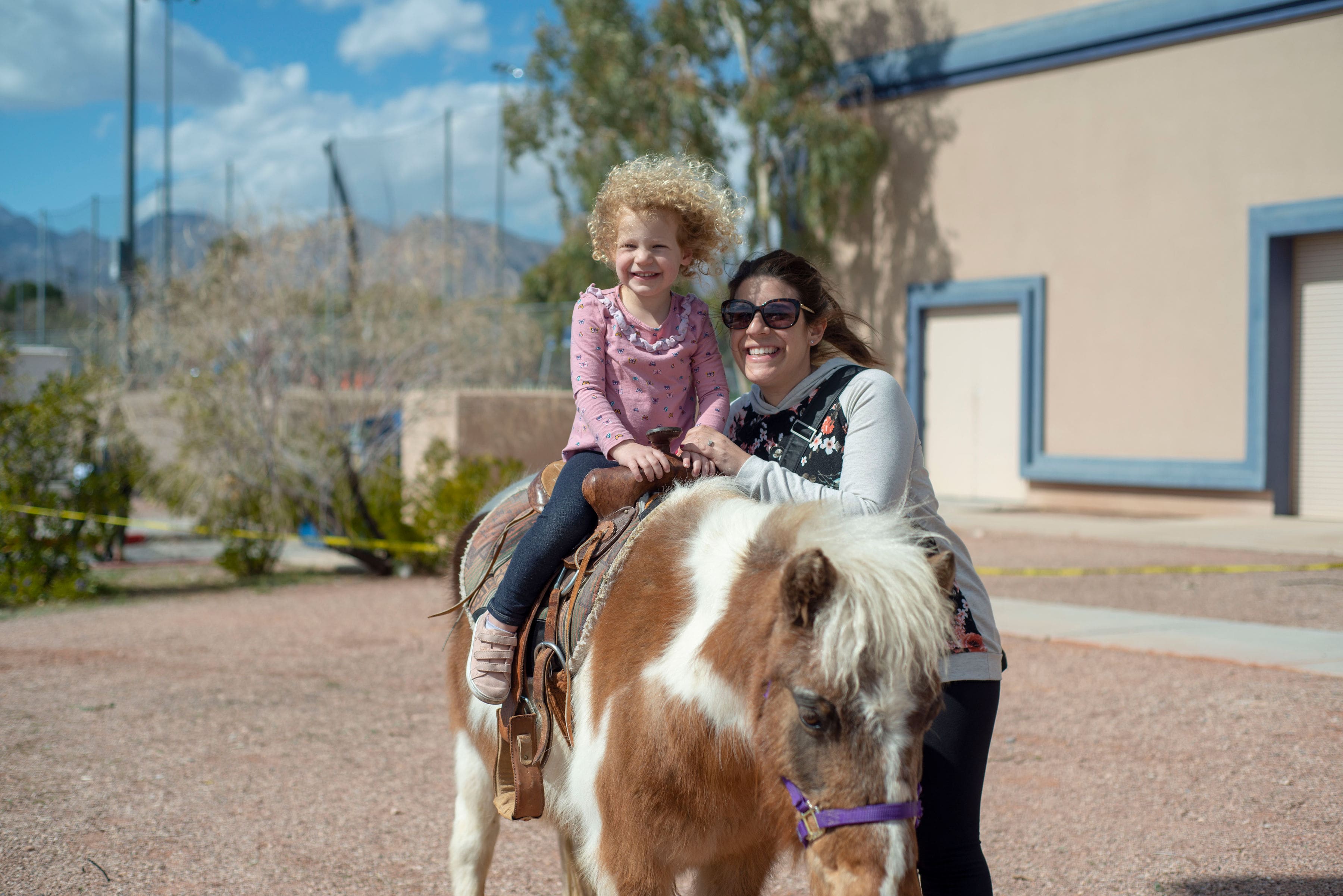 kid on pony ride with friend at at Walk4Friendship fundraiser in Las Vegas, NV 
