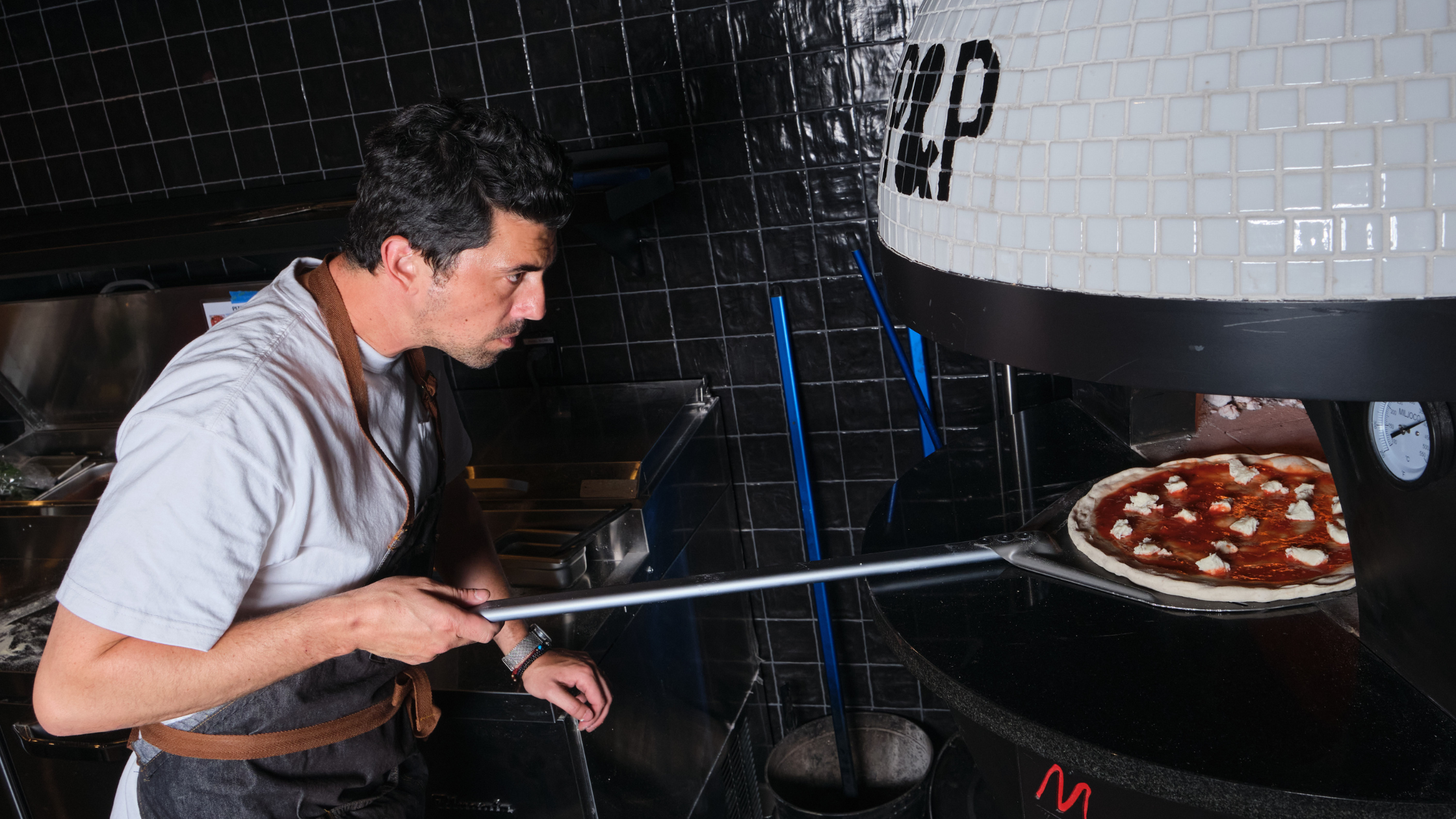 man using pizza oven
