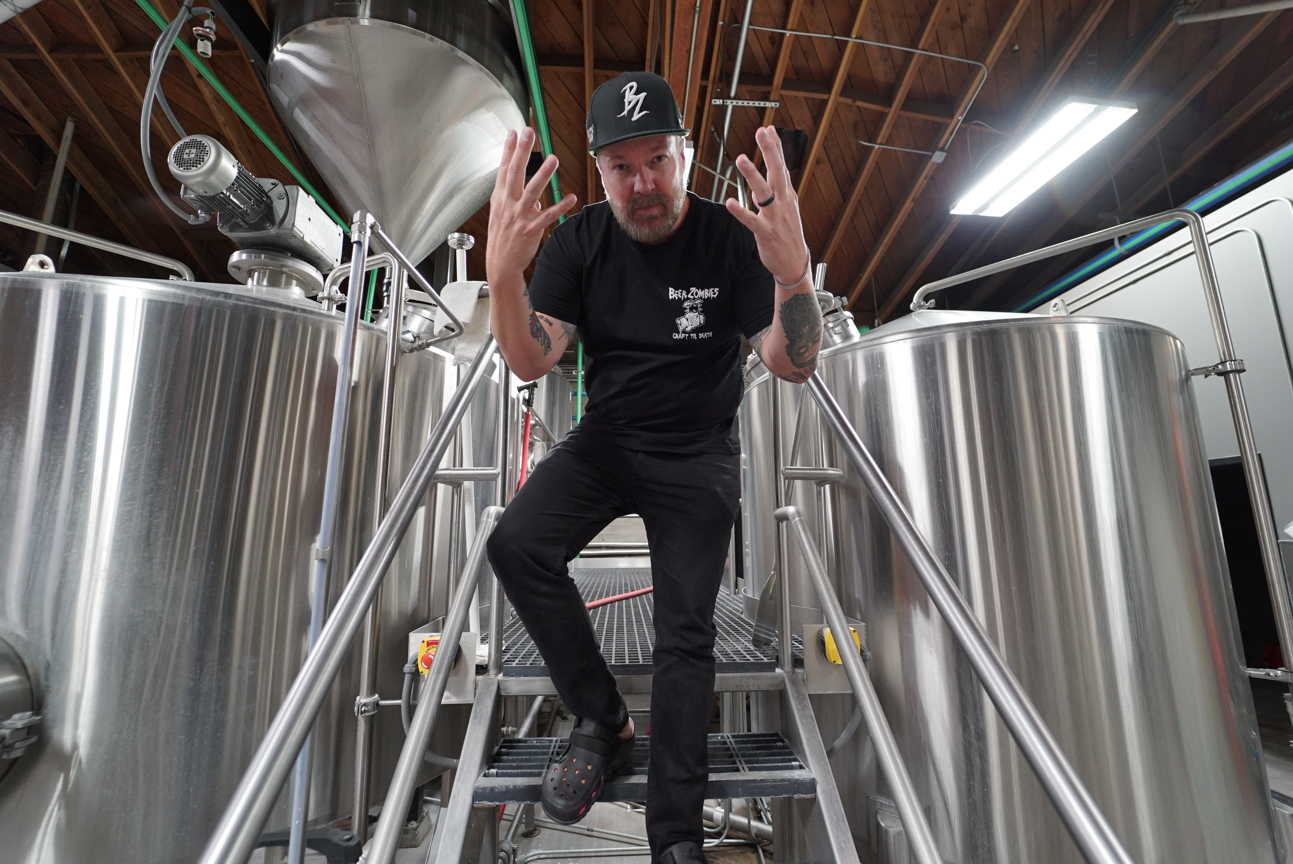 brewer in front of mash tuns